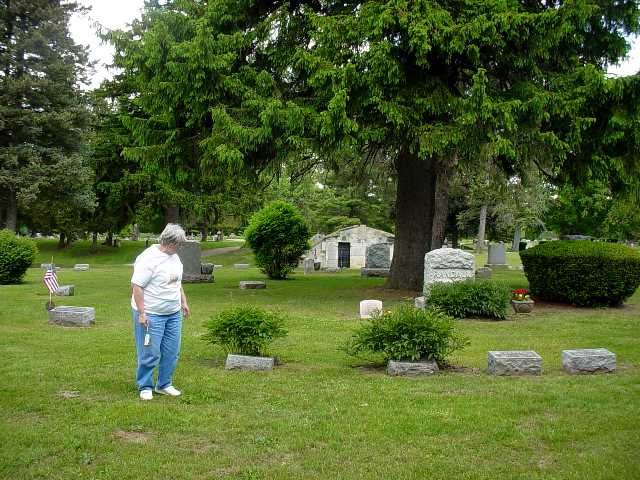 Mary Randall looking at peonies that Flora and Fred Randall loved to grow