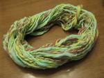 Blue and violet dyed spun yarn plied with bright green spun yarn thumbnail.