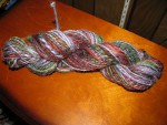 Jewel tones (green, blue, orange, and red) spun and plied yarn thumbnail.