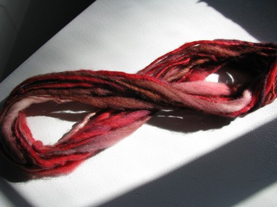 Red, brown, and white spun yarn.